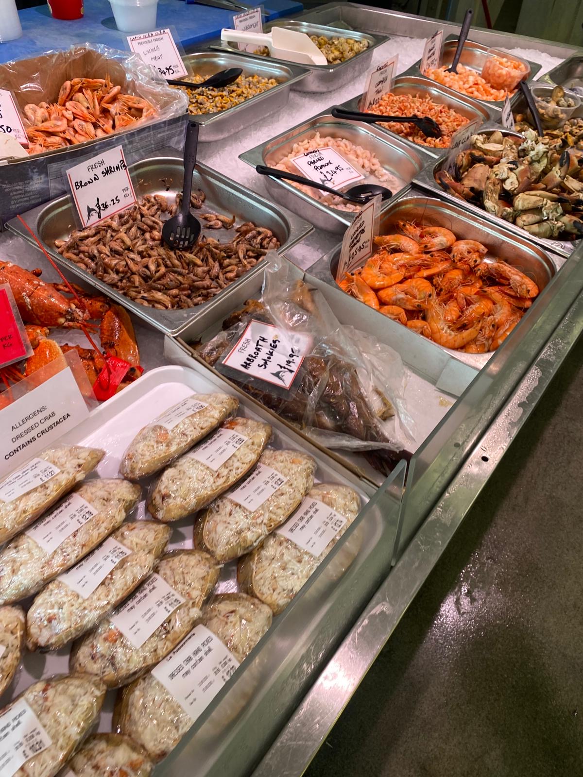 A close look at the seafood counter, including prawns and dressed crab
